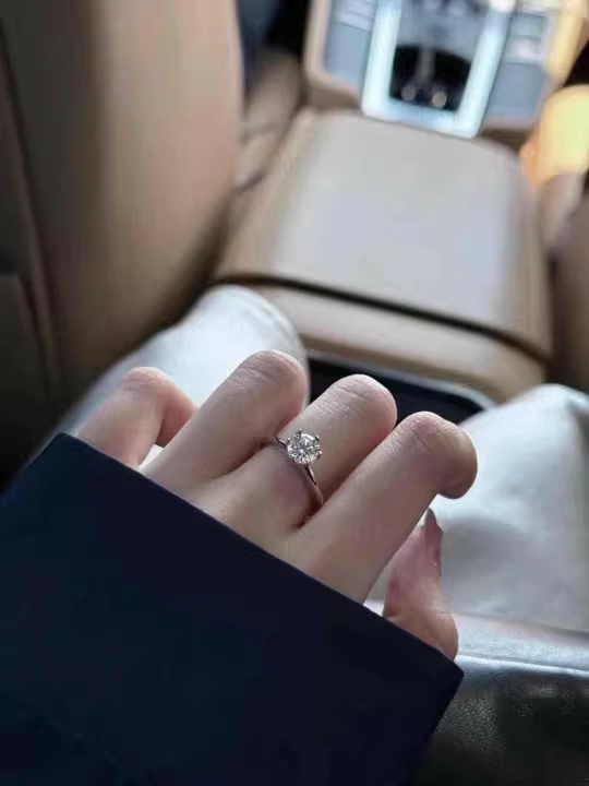 close up 6 prong moissanite ring solitaire sparkle detail natural light hand photo