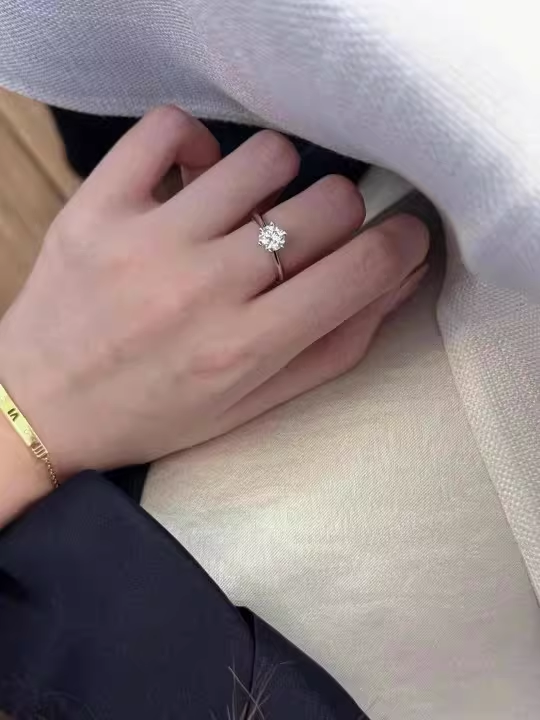 woman wearing 6 prong moissanite solitaire ring 0.5ct elegant daily wear close up hand